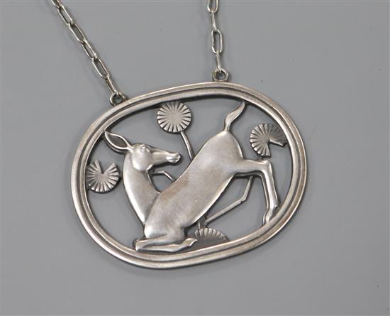 A Danish Georg Jensen sterling silver oval kneeling deer pendant on chain, no.95, 1933-1944 mark, 43mm.